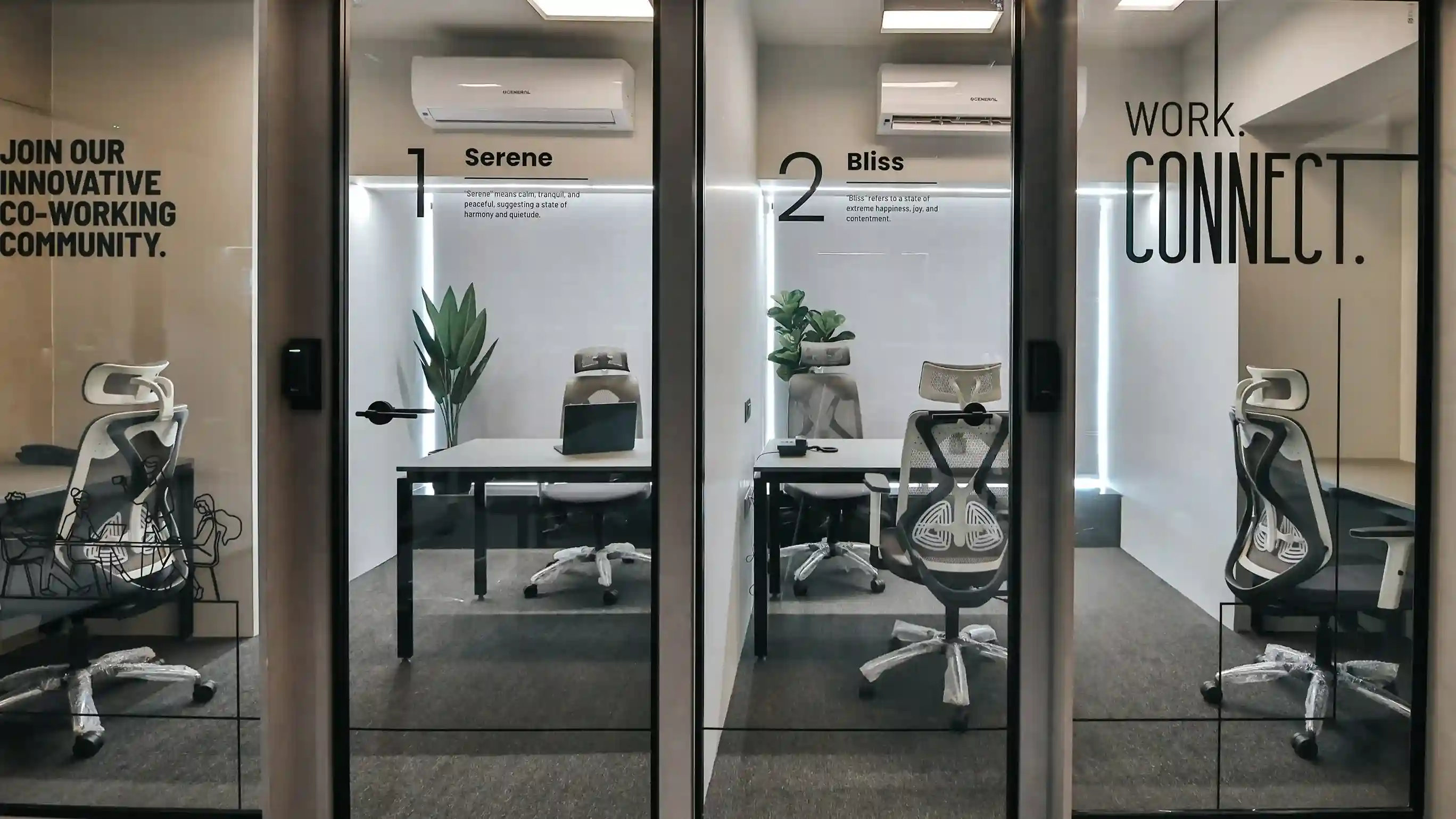 Modern coworking office with private glass cabins labeled Serene and Bliss, featuring ergonomic chairs, minimalist desks, indoor plants, and bright ambient lighting for a productive work environment.