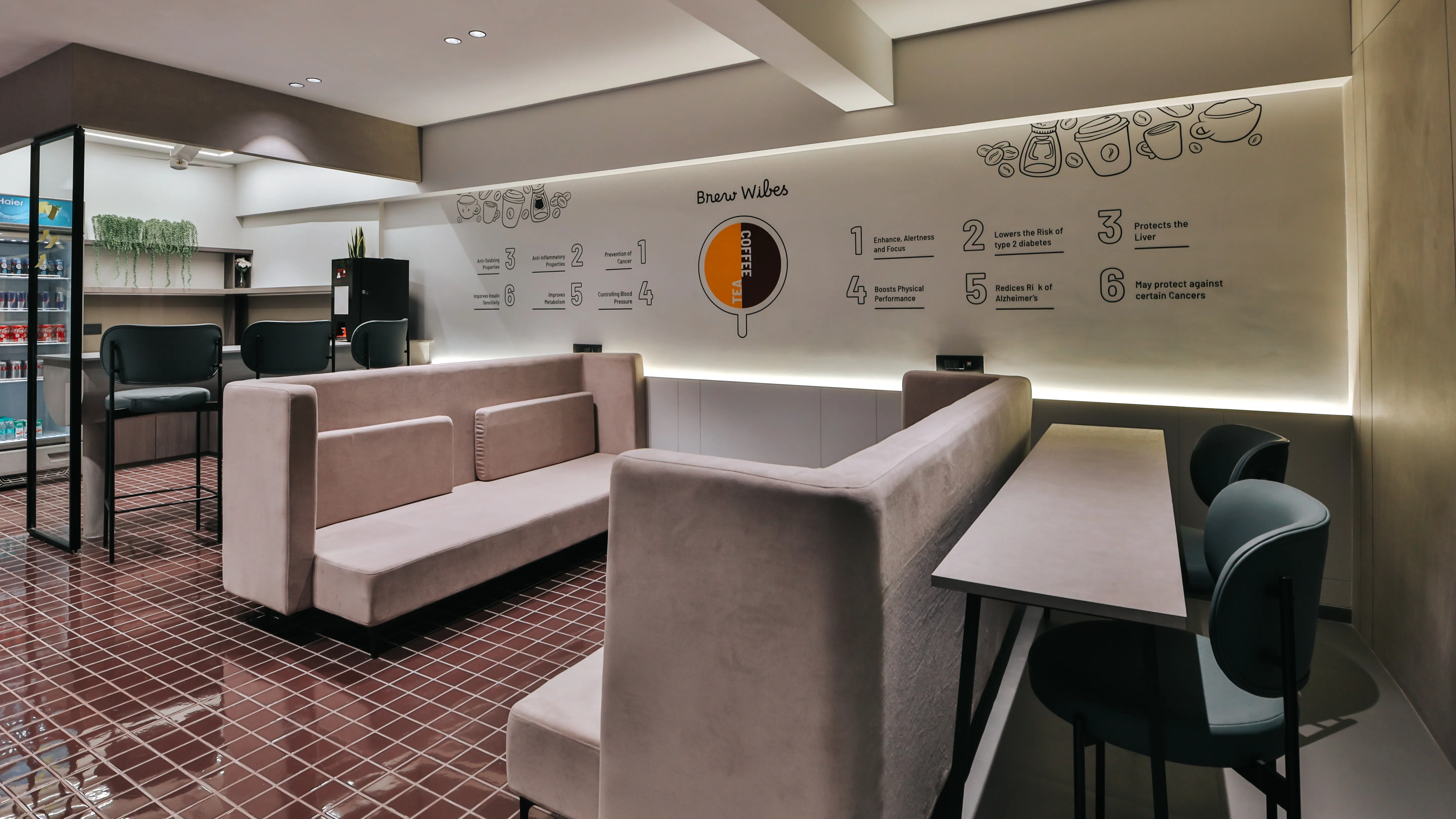 Contemporary coworking lounge area with comfortable seating, coffee station, and collaborative workspace designed for professionals and startups